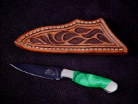 "Nekkar" obverse side view in mirror polished, hot blued O1 high carbon tungsten-vanadium tool steel blade, nickel silver bolsters, Malachite gemstone handle, hand-carved leather sheath