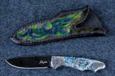 "Thuban" obverse side view in hot-blued 1095/nickel damascus blade, hand-engraved 304 stainless steel bolsters, Shattuckite gemstone handle, hand-carved, hand-dyed leather sheath